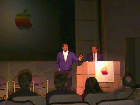 Steve Jobs and Gil Amelio Apple's QuickTake camera, used to take this picture, did a poor job reproducing color. The purple jackets were actually black.
