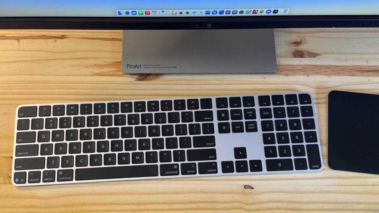 Black Magic Keyboard Full-size Top Down Black Magic Keyboard next to a Trackpad and display.