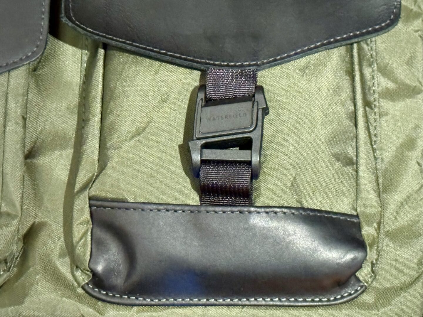Fidlock buckle WaterField Designs X Air Duffel Close-up photo of Fidlock magnetic buckle on WaterField Designs X-Air Duffel bag.